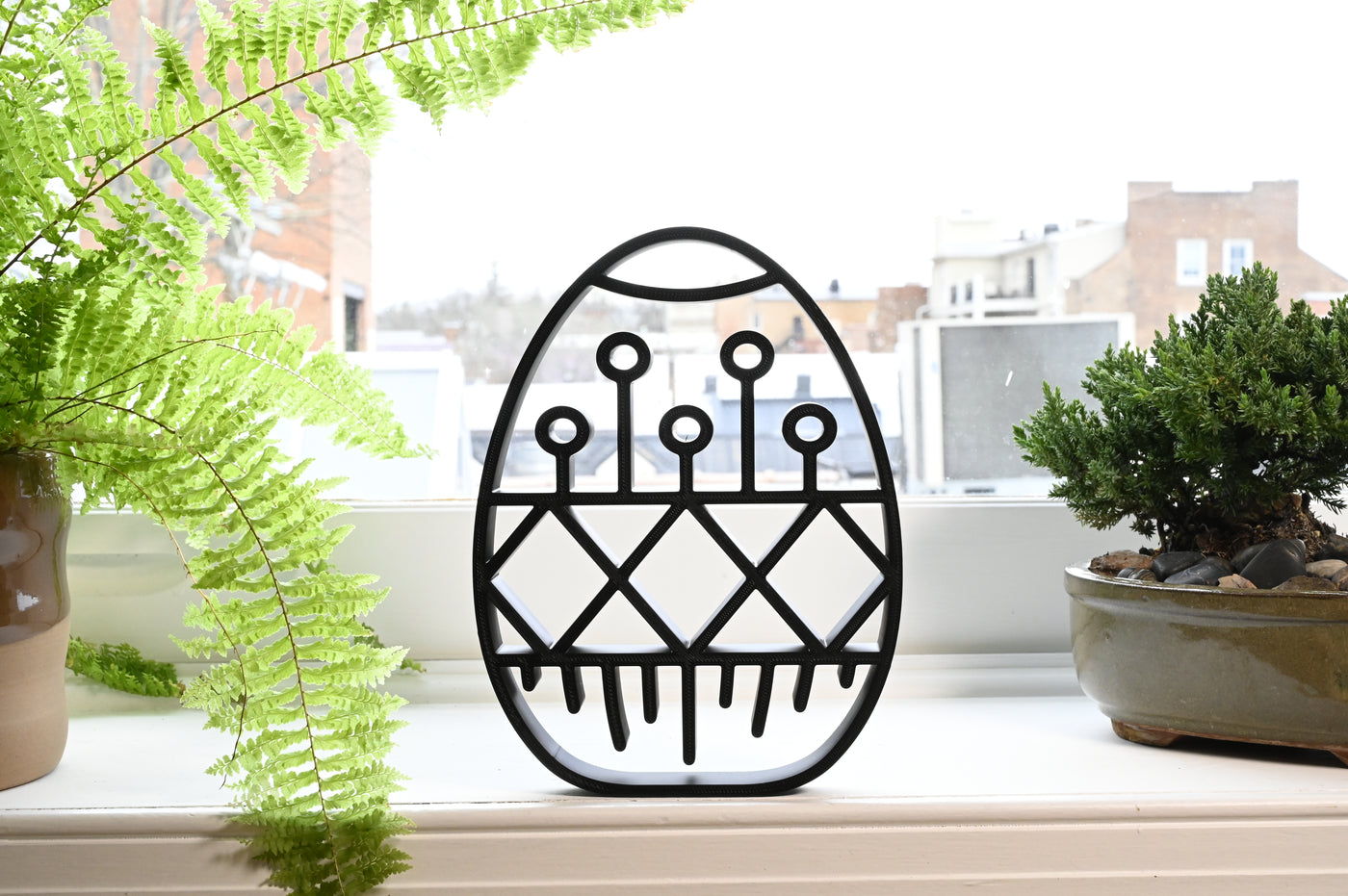 Previous black freestanding Geometric Pattern Easter egg line-art sculpture lifestyle image.