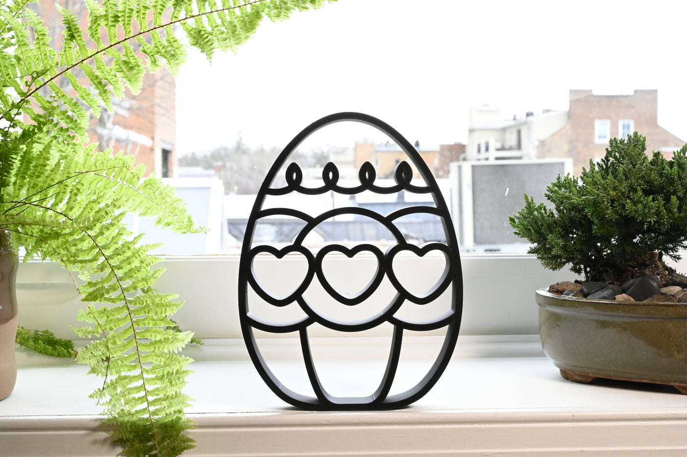 Previous black freestanding Heart Trio Easter egg line-art sculpture lifestyle image.
