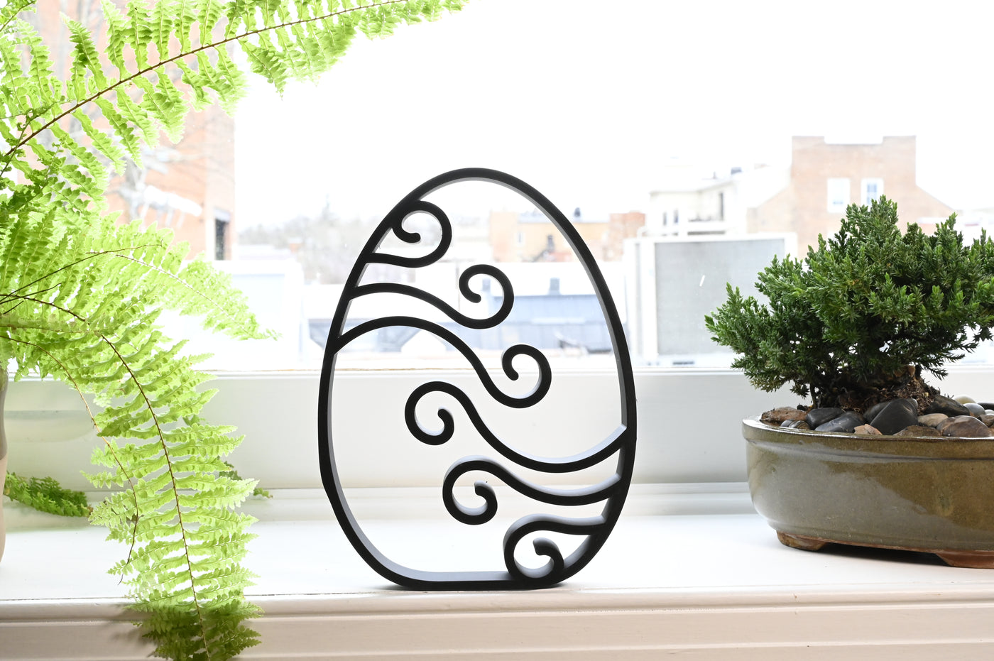 Previous black freestanding Abstract Waves Easter egg line-art sculpture lifestyle image.