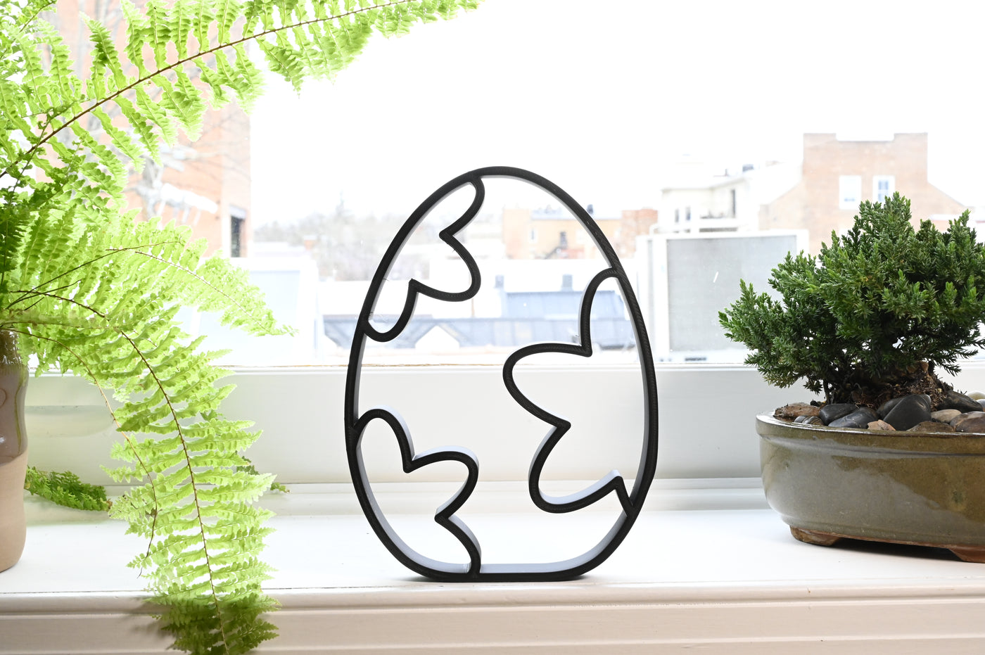 Previous black freestanding Bubbly Stars Easter egg line-art sculpture lifestyle image.